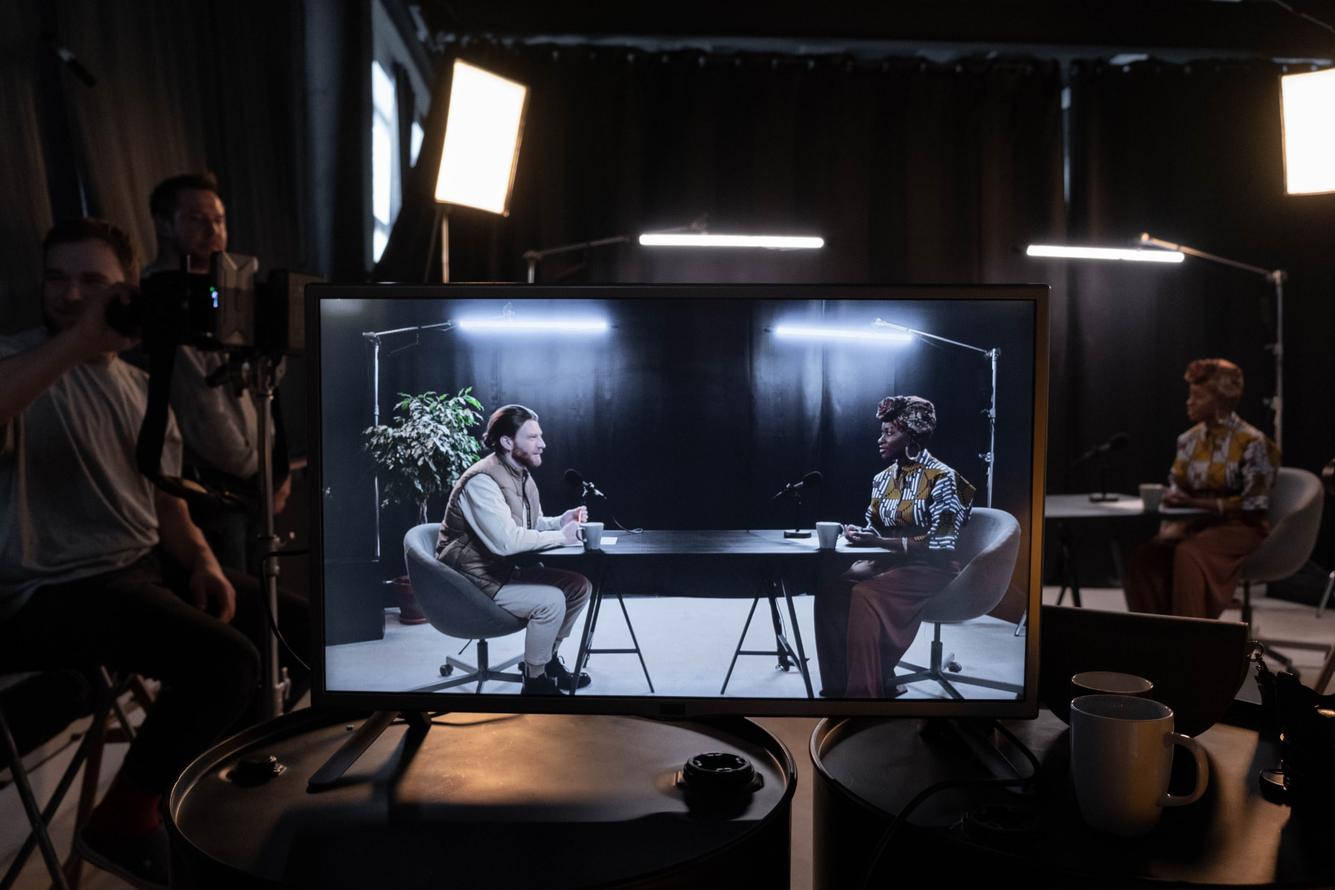Director's monitor showing a podcast interview on a film set